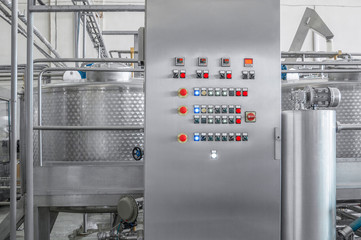 control panel with buttons and a tank at a beverage factory, close-up. factory shop for the...