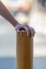 Close up of hand on yellow pillar