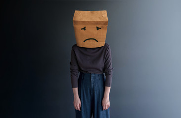 Customer Experience or Human Emotional Concept. Woman Covered her Face by Paper Bag and present Sad...