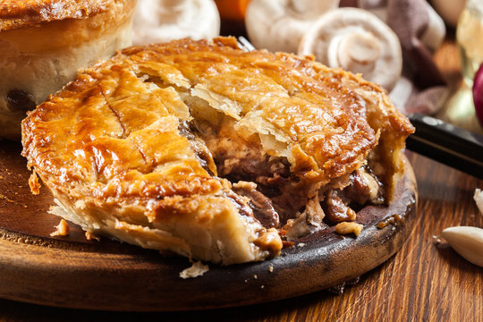 Fresh beef stew pie on a cutting board