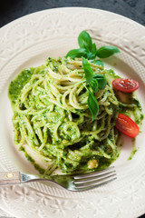 Pasta spaghetti with homemade basil pesto sauce on white plate
