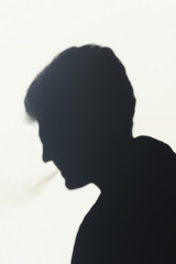 shadow of smoking man, young man smoking a cigarette, concept abstract background