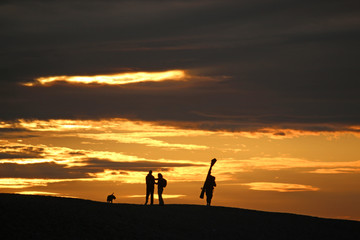 Anglers on Chesil Bank at sunset