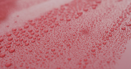 closeup of raindrops on ceramic coated red car with hydrophobic effect