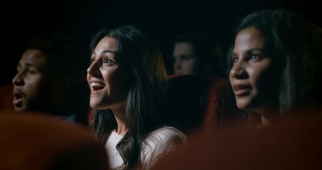Young, diverse audience at a crowded movie theatre