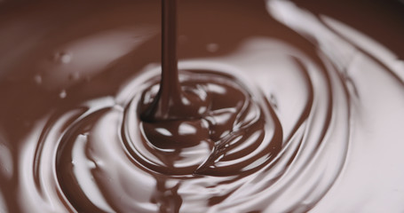 closeup pouring molten dark chocolate