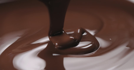 closeup pouring molten dark chocolate