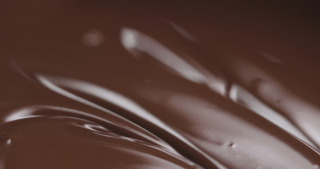 closeup melted dark chocolate with spoon