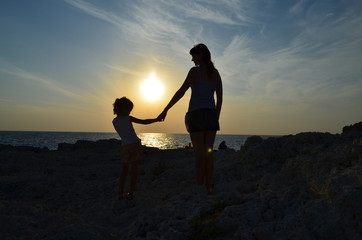 mother and daughter at sunrise