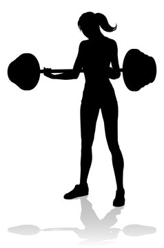 A woman in silhouette using barbell weights fitness exercise gym equipment 