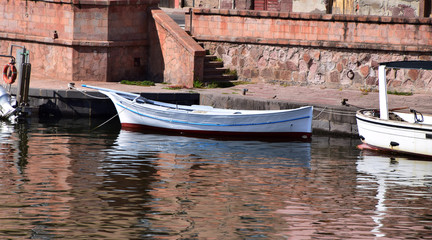 typical small fisching boats in sardinia, panoramic view on the boats on the river temo in Bosa in...