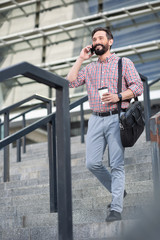 Full length of a cheerful man walking down the stairs