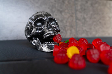 Skull Eating Chewy red Candy during halloween