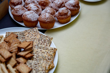 Tasty muffins and sweets on a plate