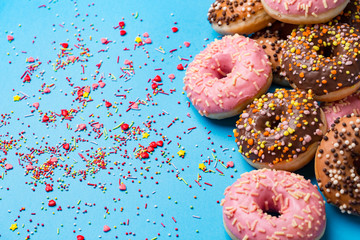 the Colorful round donuts on blue background.