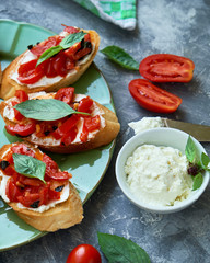 Italian bruschetta with chopped tomatoes, basil and cheese on grilled crusty bread