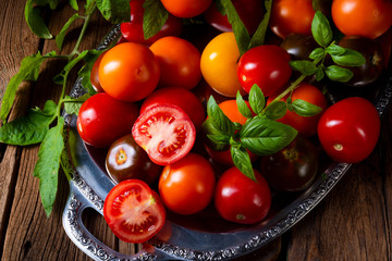 various types of tomatoes served and presented on the silver platter.