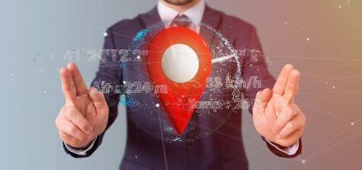 Businessman holding a 3d rendering pin holder on a globe with coordinates