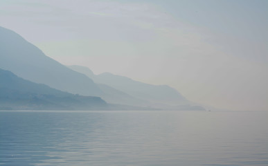 Misty mountains across the ocean