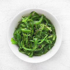 Wakame seaweed salad with sesame seed. Traditional Japanese food. Top view.  © masterq