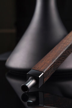 Modern hookah isolated on dark background. rosewood mouthpiece