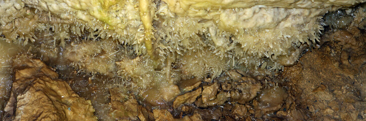 wonderful natural cave with brown walls and formations of Helicctites in it, natural texture image.