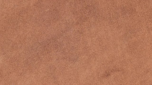 Rotation of natural suede leather. Brown chamois texture. Fluffy and soft shammy-leather.