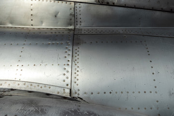 Texture, Aluminum fuselage and rivets on an old plane. Old technologies. copy space