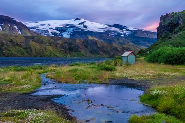 Midnight sun during the summer solstice in Thorsmork in the Highlands of Iceland at southern end of the famous Laugavegur hiking trail. The top of the Eyafjallajokul can be seen in the background