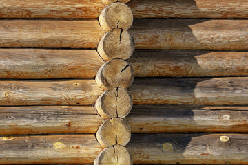 Wall with log house in the house as a background