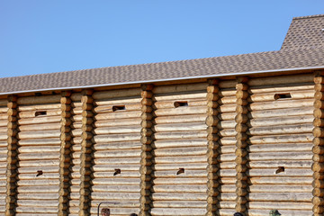 Wall with log house in the house as a background