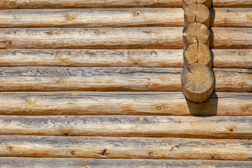 Wall with log house in the house as a background