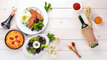 Assortment of dishes of Georgian and European cuisine. On the old wooden background. Free space for text. Top view.