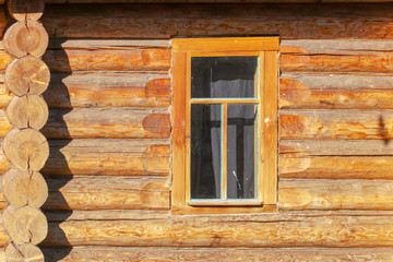 Window in the house with a log house