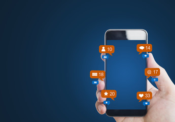 Hand holding mobile smart phone, with notification icons and blank empty screen