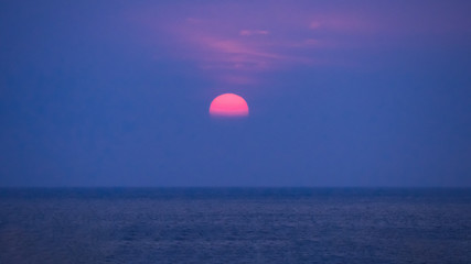 red sunset above the blue ocean