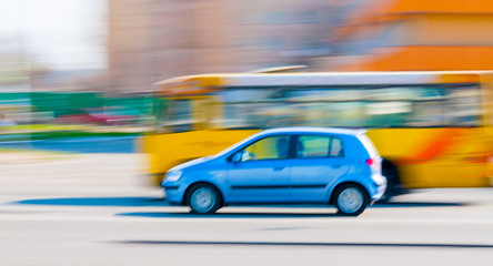 Fototapeta na wymiar A blue car driving fast in the city of Kiev, Ukraine