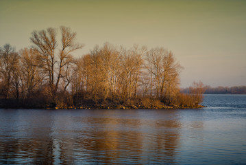 Fototapeta premium Early morning with trees reflection on the Early morning with trees reflection on the Dnieper river in winter. Kiev, Ukrainenieper river in winter. Kiev, Ukraine