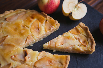 Delicious apple autumn pie on a dark background