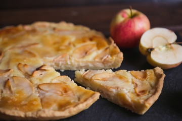 Delicious apple autumn pie on a dark background