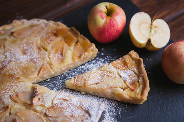 Delicious apple autumn pie on a dark background