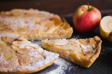 Delicious apple autumn pie on a dark background