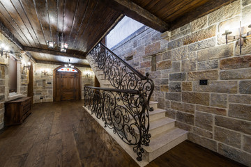 Stairs with wrought iron in luxury home celler