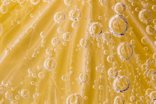 Bubbles on a lemon in soda water