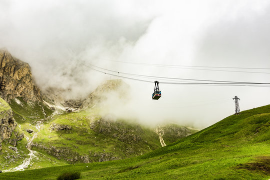 Sass Pordoi is easily one of the most visited mountains of the Dolomites. A cable-car, just visible as it enters the clouds, leads up from the road pass to its summit. The cable-car is free hanging.