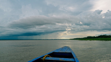 stormy and cloudy weather at the amazonas in peru. view from a boat