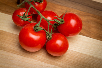 Cherry tomatoes on wooden cutting board