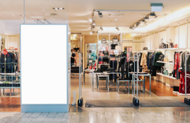 Clothes shop entrance with empty billboard mockup to place text, logo or advertisement 