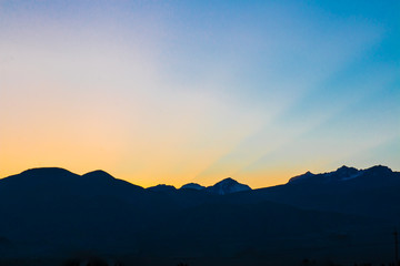 Sun rising behind the mounrains.