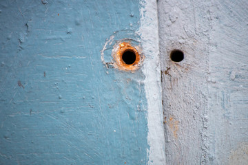 Metal rusty surface with a hole on the screw